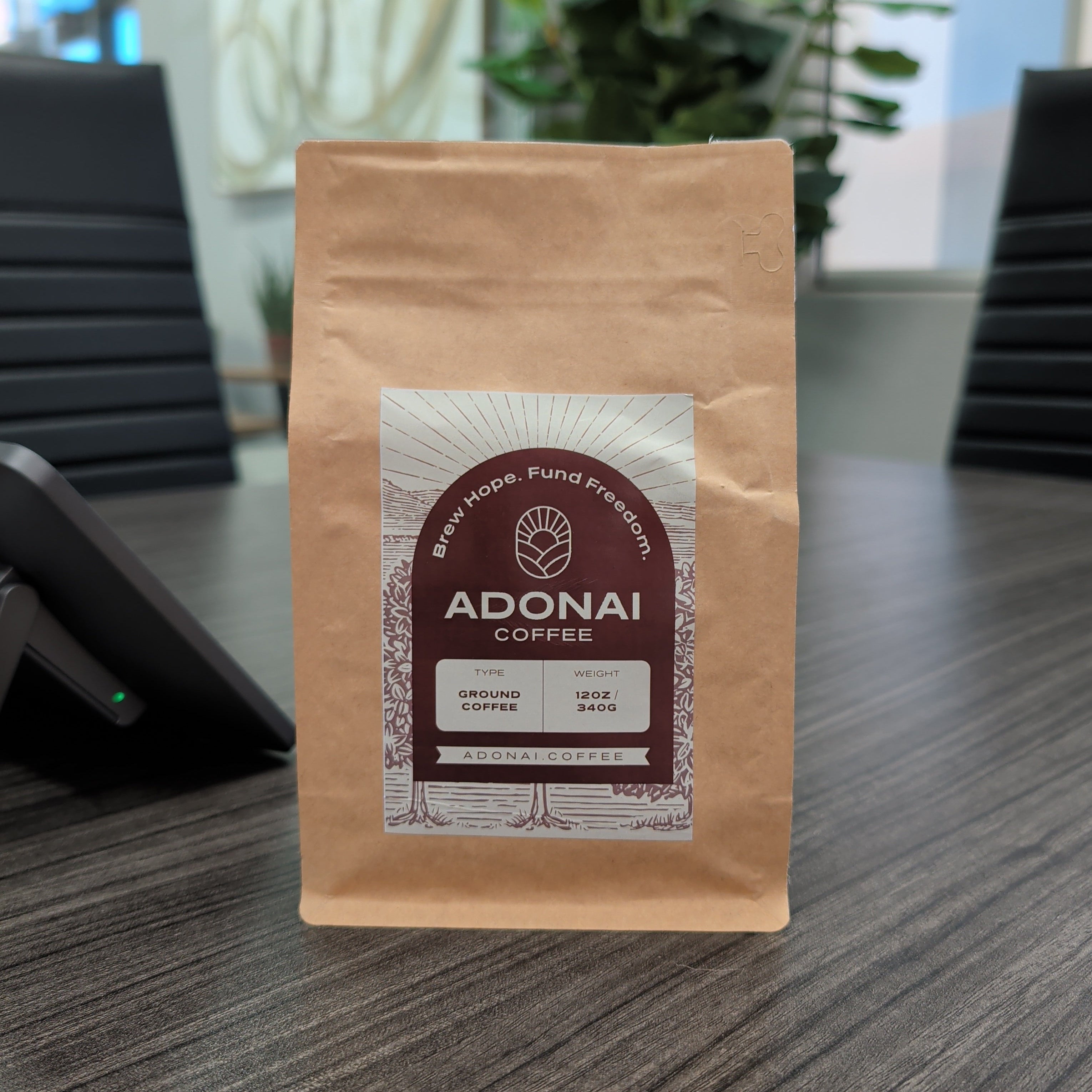Adonai Coffee package on a desk with a blurred background